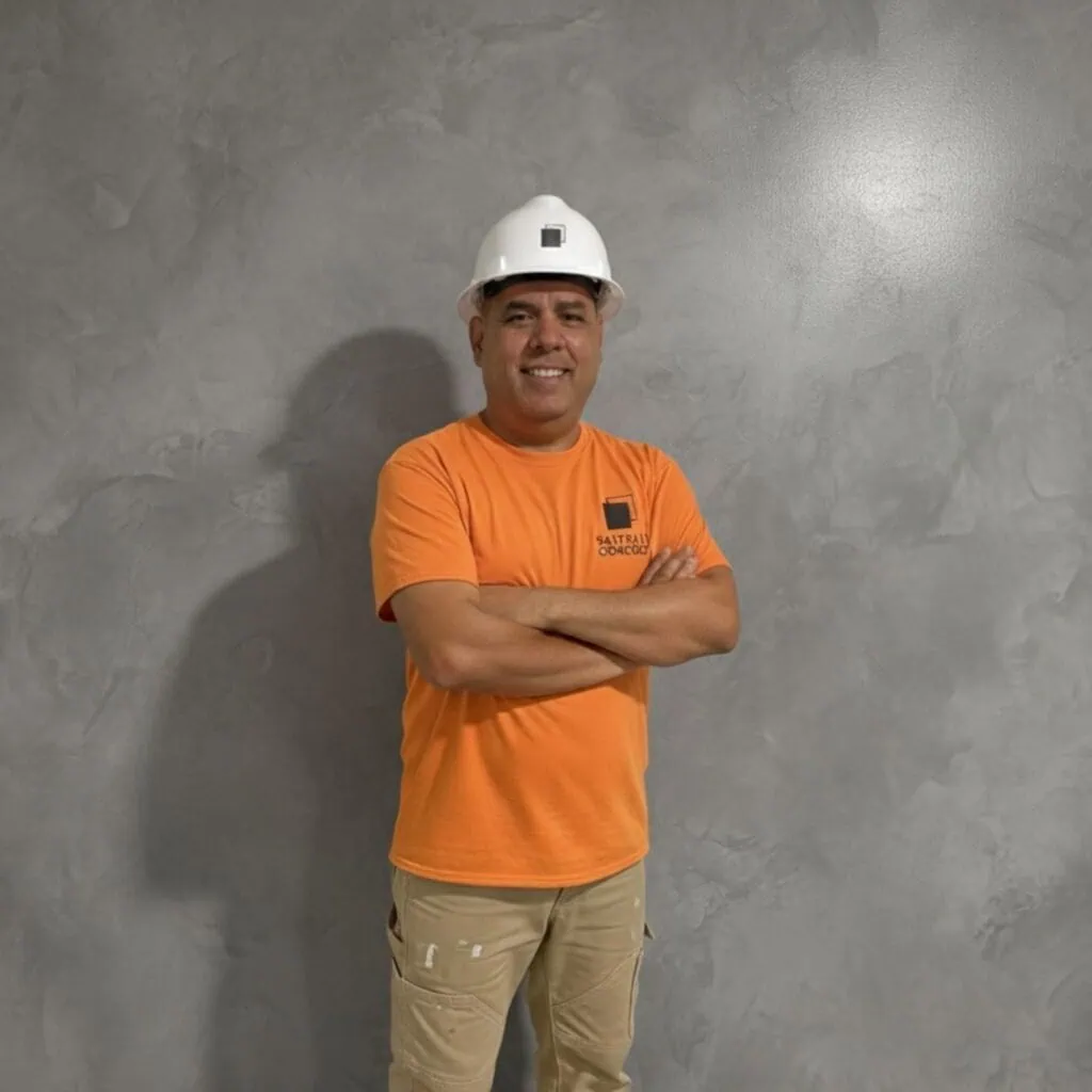 SafePath Concrete worker in a white hard hat standing in front of a smooth concrete wall